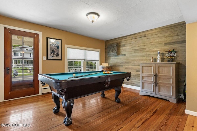 playroom featuring wooden walls, billiards, hardwood / wood-style floors, and a textured ceiling