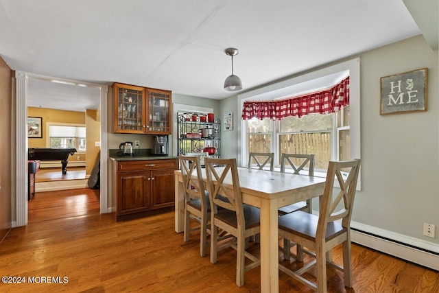 dining space with wood-type flooring, baseboard heating, pool table, and indoor bar