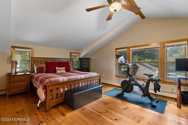 bedroom featuring light wood-type flooring, lofted ceiling, and multiple windows