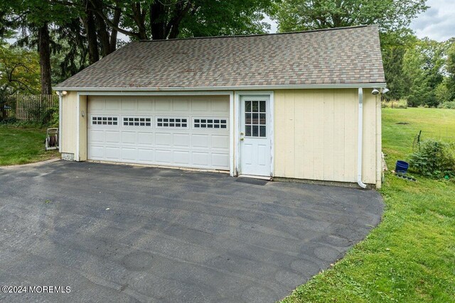 garage featuring a yard