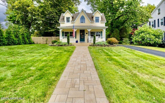 view of front of home with a front yard and a porch