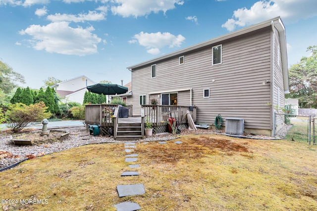 back of property featuring a yard and a wooden deck