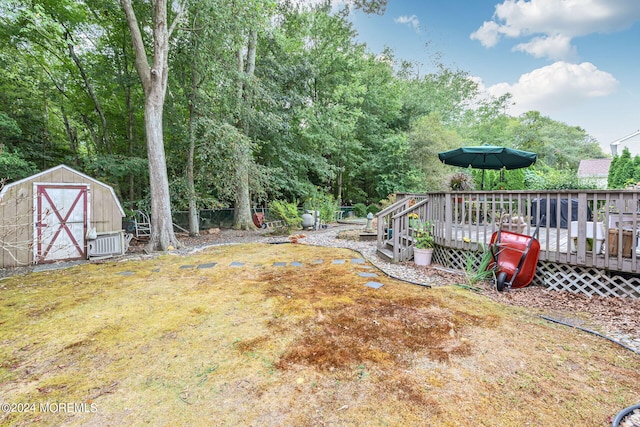 view of yard with a storage shed, cooling unit, and a deck