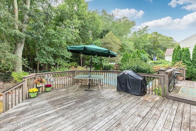 wooden terrace with a grill