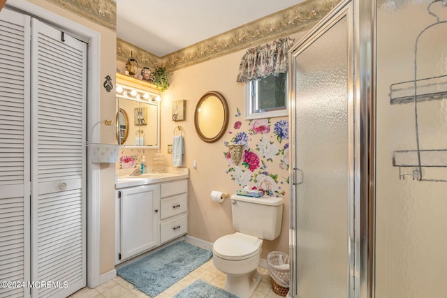 bathroom featuring walk in shower, vanity, toilet, and tile patterned floors