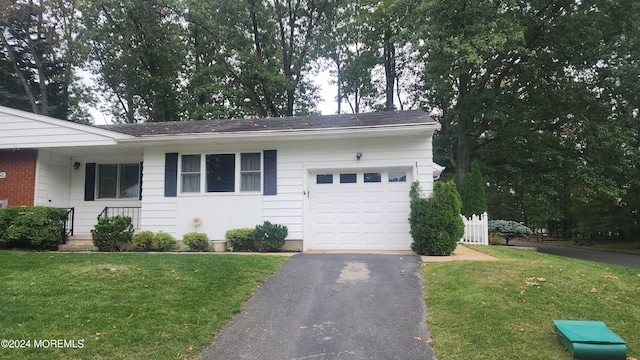 ranch-style home with a front lawn and a garage