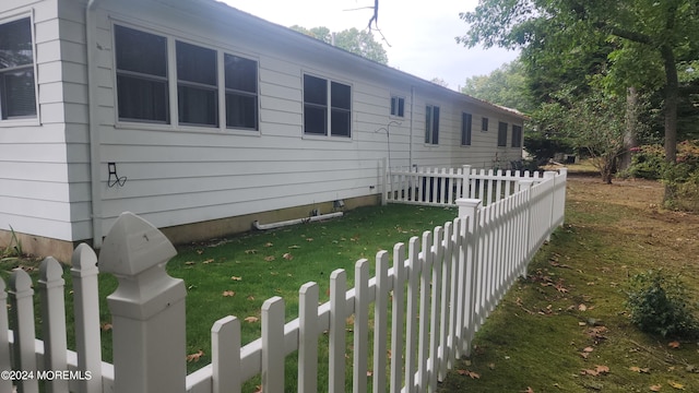 view of side of home with a lawn