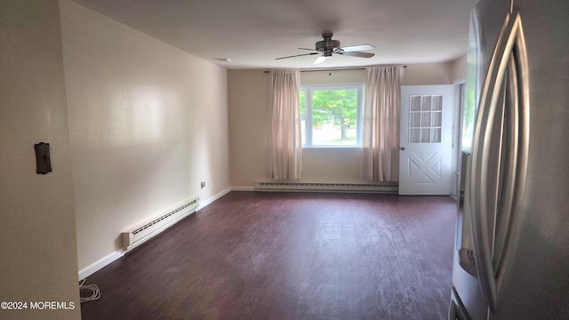 empty room with a baseboard heating unit, ceiling fan, and dark hardwood / wood-style floors