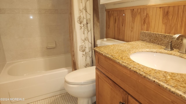 full bathroom featuring vanity, toilet, shower / bath combo with shower curtain, and tile patterned floors