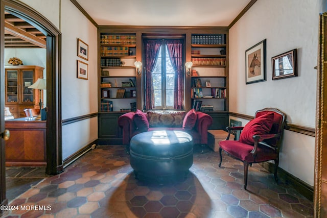 sitting room with crown molding and built in features