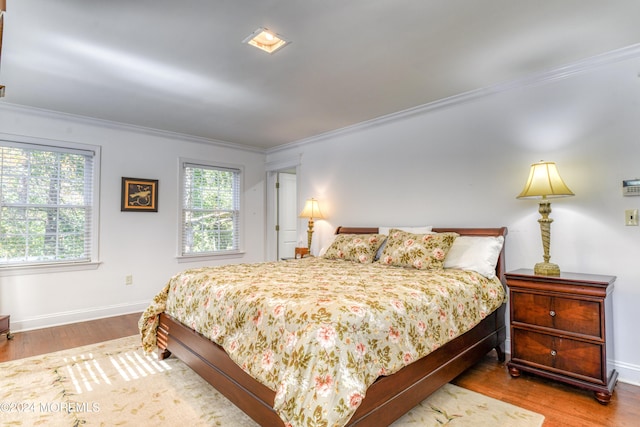 bedroom with wood-type flooring and crown molding