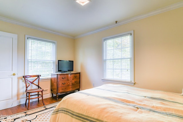 bedroom with ornamental molding and hardwood / wood-style flooring