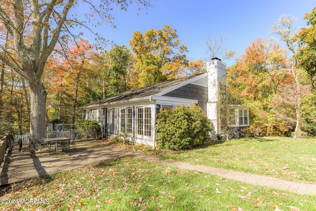 view of home's exterior with a lawn and a patio