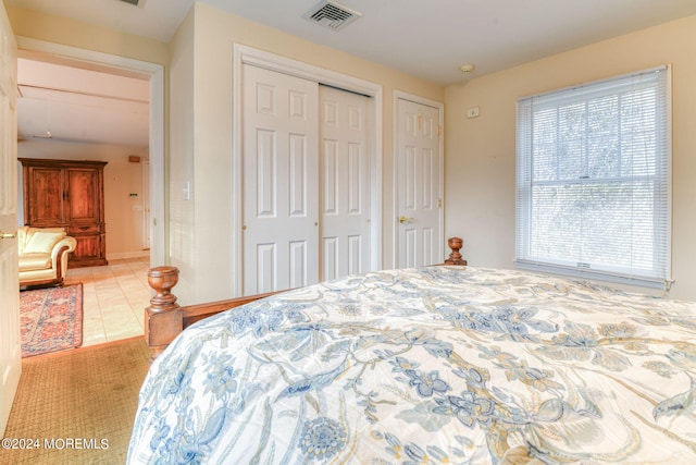 tiled bedroom featuring two closets