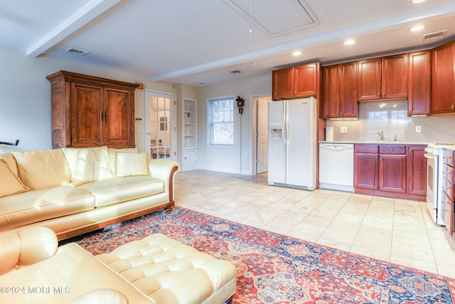 tiled living room featuring beamed ceiling