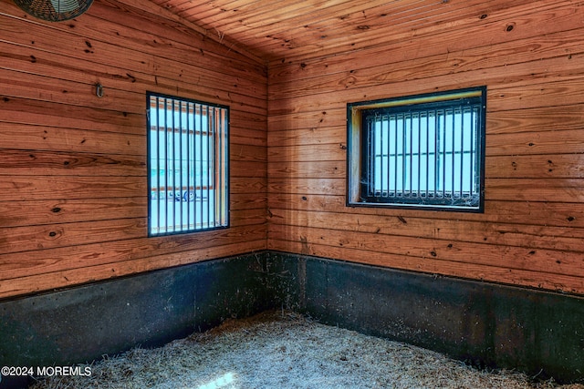 empty room with wood ceiling and wood walls