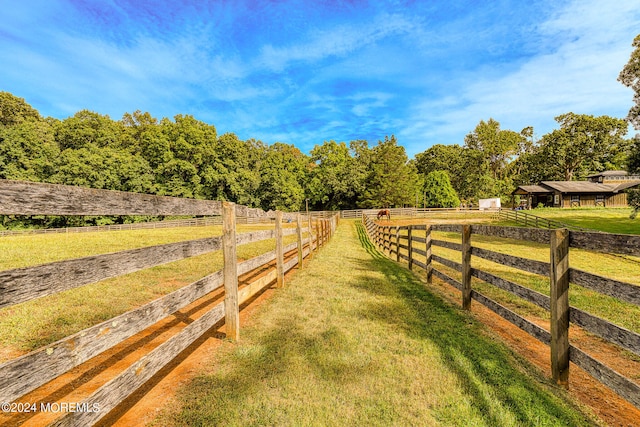 view of yard featuring an outbuilding and a rural view