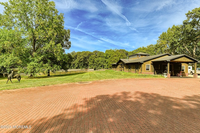 exterior space featuring a rural view and a front yard