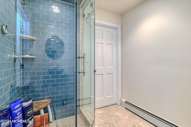 bathroom featuring a baseboard heating unit and an enclosed shower