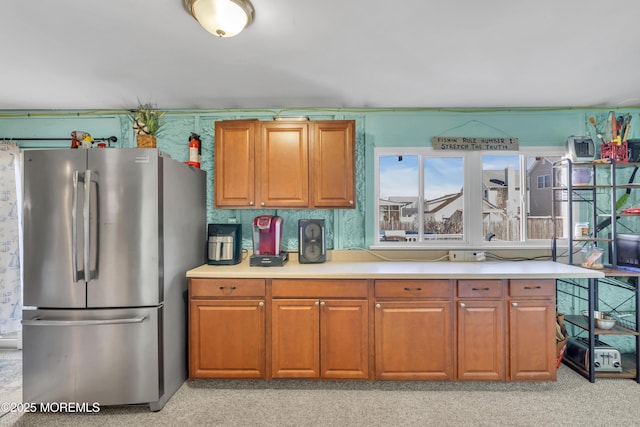 318 Bayview Ave, Union Beach, NJ 07735 - kitchen with brown cabinets, freestanding refrigerator, light countertops, and light carpet
