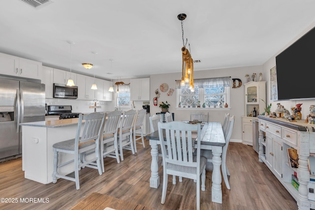 318 Bayview Ave, Union Beach, NJ 07735 - dining area featuring visible vents and wood finished floors