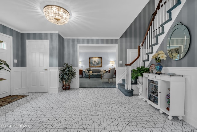 foyer featuring an inviting chandelier and ornamental molding