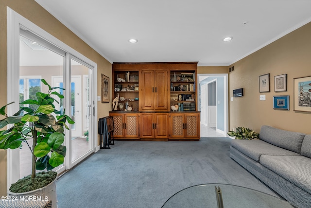 carpeted living room with ornamental molding