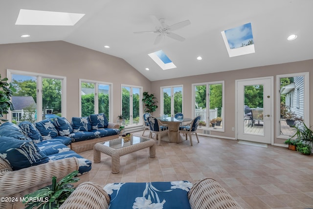 living room featuring vaulted ceiling with skylight, ceiling fan, and light tile patterned floors