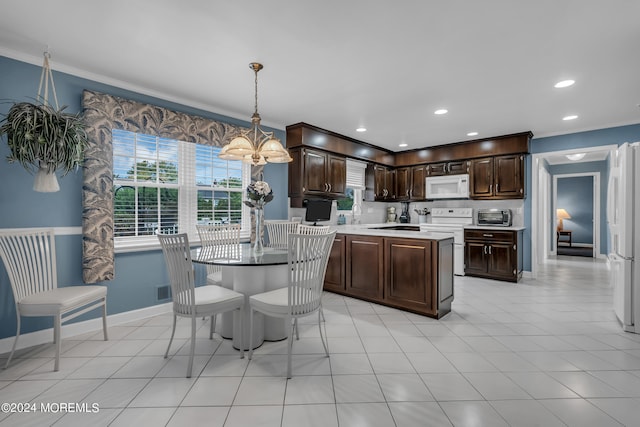 kitchen with hanging light fixtures, white appliances, dark brown cabinets, an inviting chandelier, and a center island