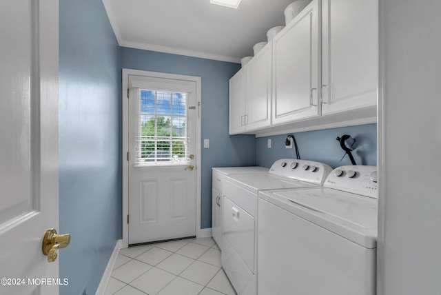 clothes washing area with washer and clothes dryer, cabinets, crown molding, and light tile patterned floors