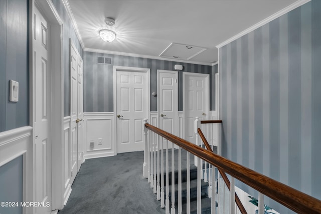 hallway featuring crown molding and dark carpet