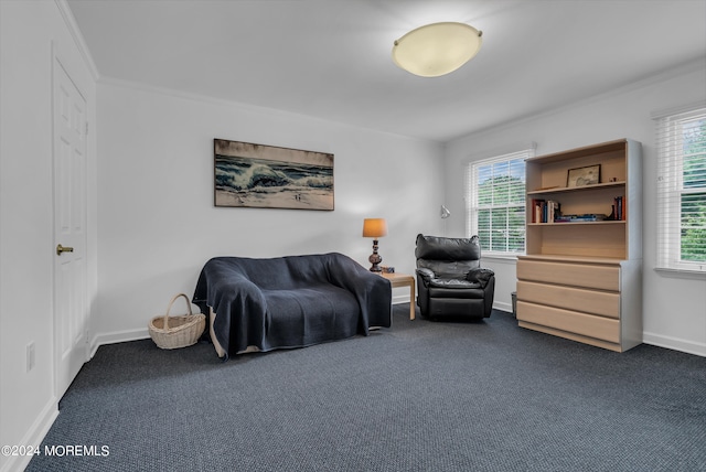 living area with crown molding and dark colored carpet