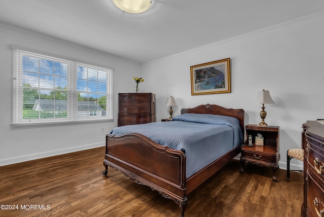 bedroom with crown molding and dark hardwood / wood-style flooring