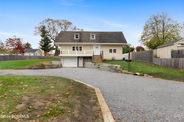 view of front of property featuring a front lawn and a garage