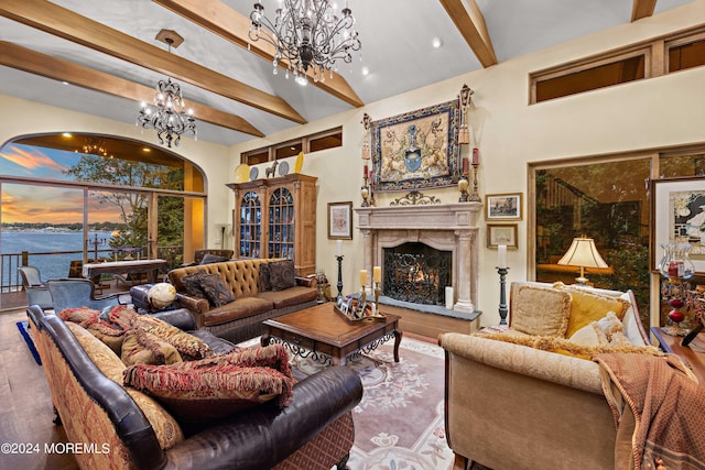 living room featuring a water view, an inviting chandelier, beamed ceiling, and hardwood / wood-style flooring