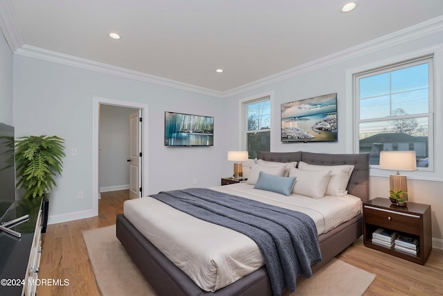 bedroom featuring light hardwood / wood-style flooring and ornamental molding