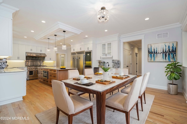 dining area featuring a chandelier, light hardwood / wood-style floors, and ornamental molding