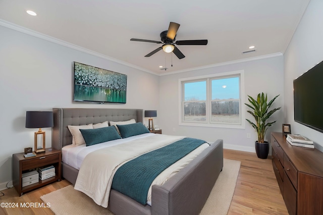 bedroom featuring ceiling fan, light wood-type flooring, and crown molding