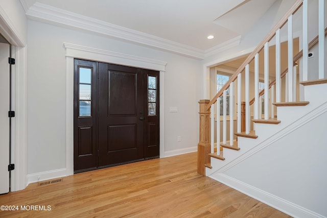 entrance foyer featuring light wood-type flooring and ornamental molding