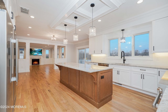 kitchen featuring a large island, light hardwood / wood-style floors, white cabinetry, and sink