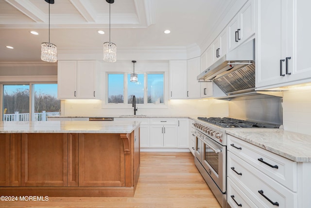 kitchen with a wealth of natural light, white cabinetry, range with two ovens, and hanging light fixtures