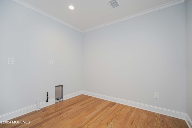 unfurnished room with crown molding and wood-type flooring