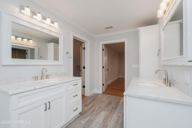 bathroom with vanity, wood-type flooring, and crown molding