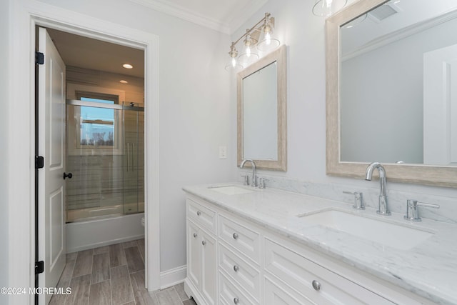 full bathroom featuring shower / bath combination with glass door, vanity, toilet, and crown molding