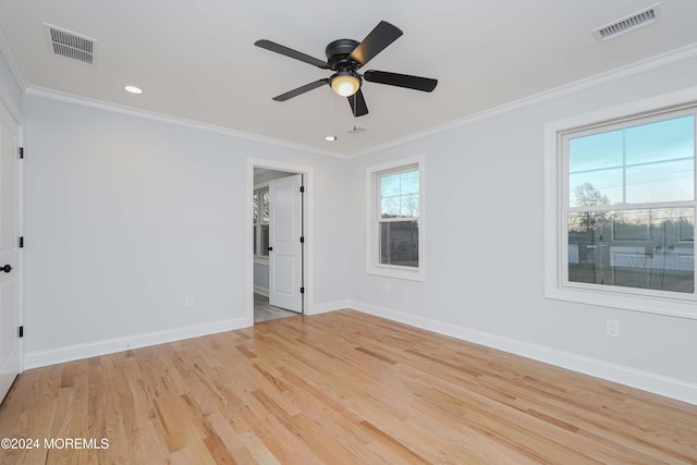 spare room with light wood-type flooring, ceiling fan, and ornamental molding