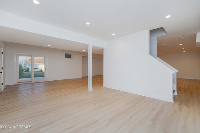 basement with light hardwood / wood-style floors