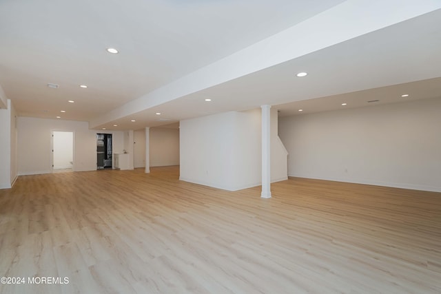 basement featuring light hardwood / wood-style flooring