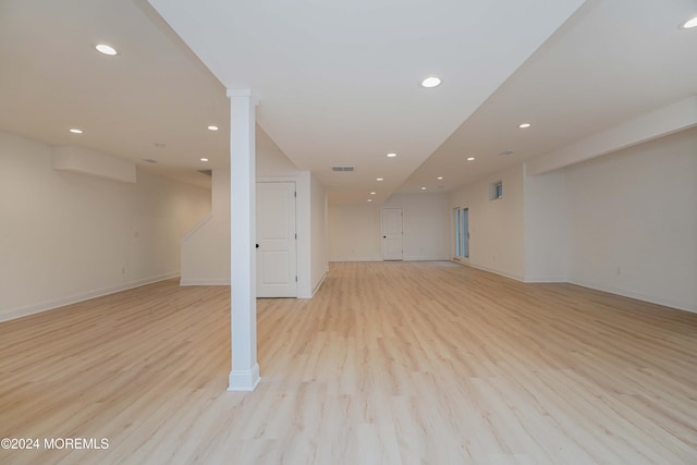 basement with light hardwood / wood-style flooring