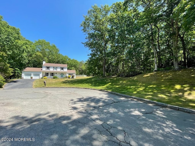 view of front of house with a garage and a front lawn