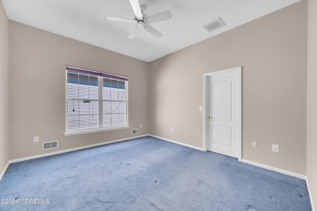 empty room with ceiling fan and carpet